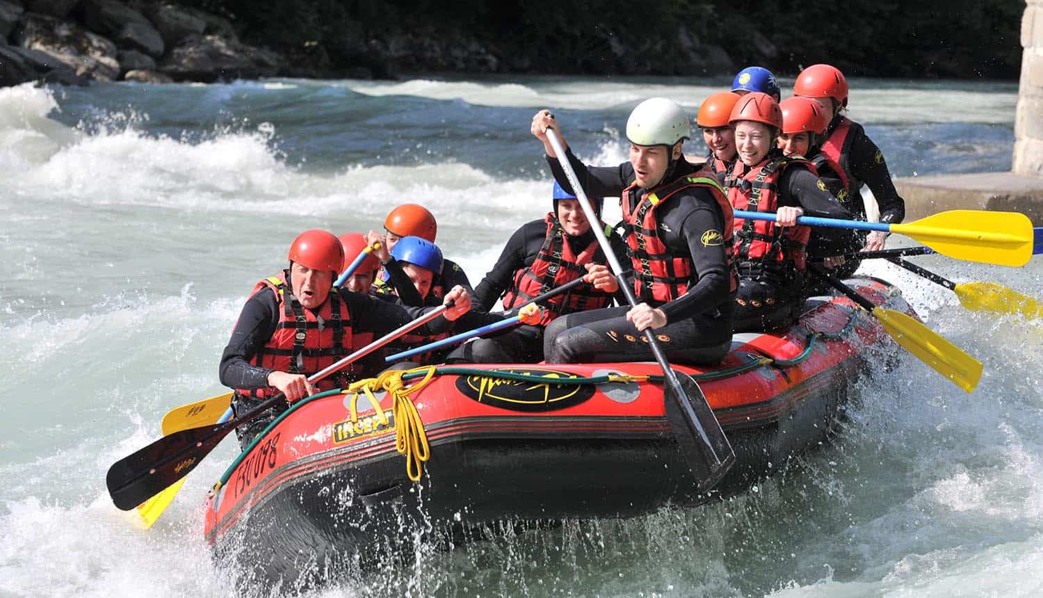 Image of team rowing a boat in river rapids representing the need for breaking down the wallsas a challenge for data protection officers