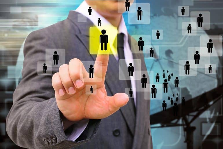 Image of man using finger to select a person in a network representing difficulty of employers finding the employee privacy sweet spot