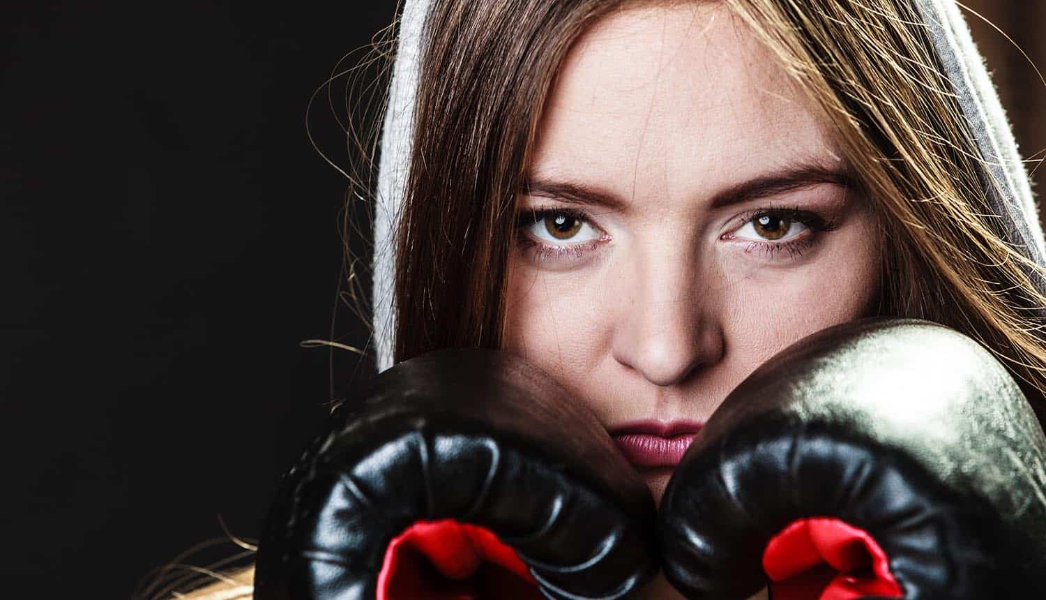 Image of woman wearing boxing gloves representing the fight in the recent U.S. vs Apple case