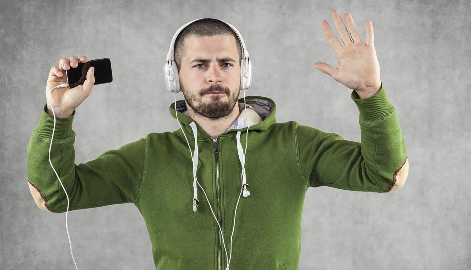 Image of man wearing headphones and arms raised representing the privacy infringement claim on Bose