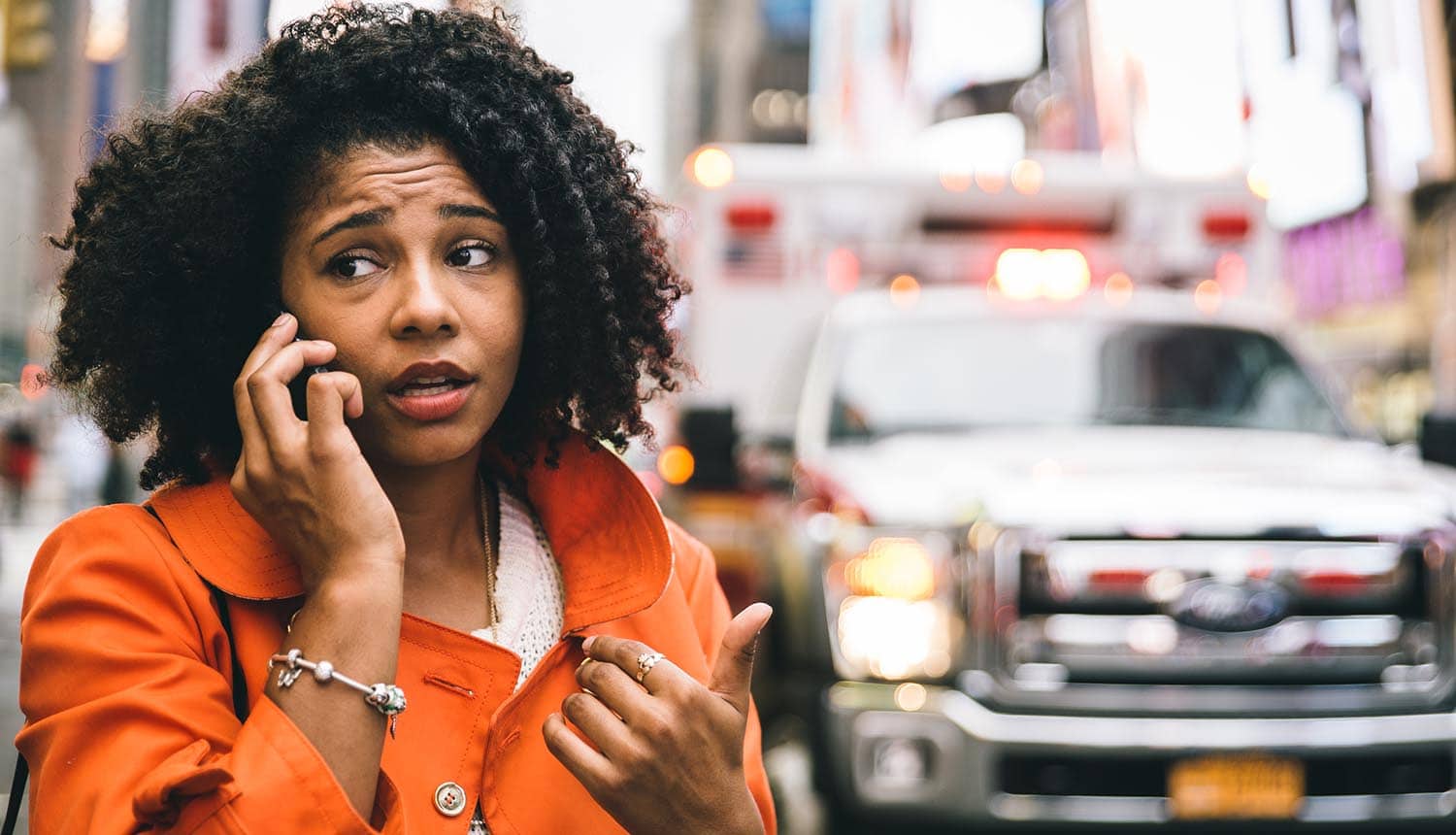 Image of distressed woman speaking on mobile phone with ambulance in the background representing changes in privacy law in Australia regarding breach reporting, big data and the new EU GDPR