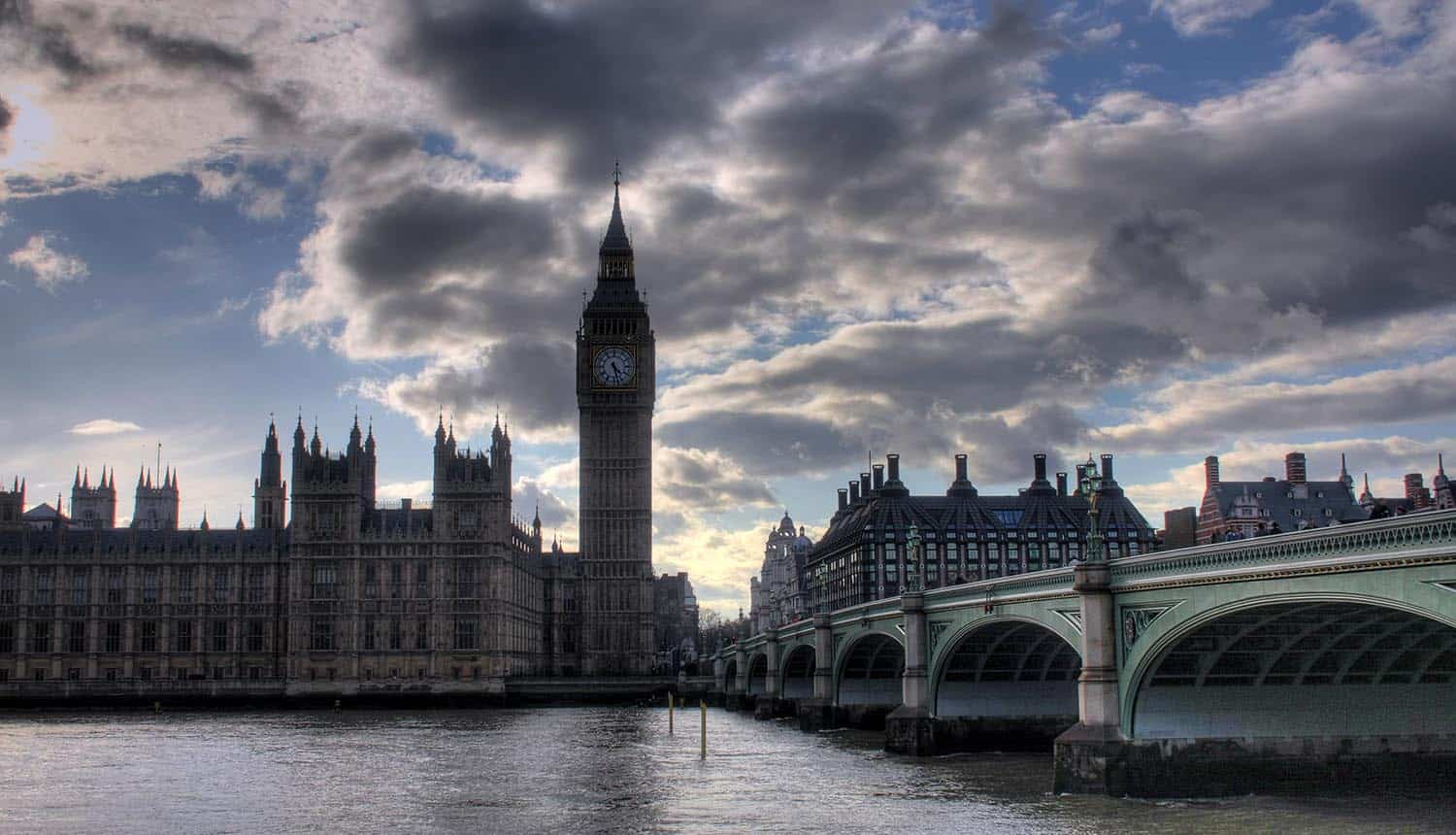 Image of UK parliament building against a dark cloudy sky representing the use of big data in politics