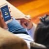 Image of woman using mobile phone showing privacy settings representing how telco will give consumers better privacy control over data