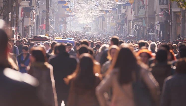 Image of crowded street with blurred faces representing how privacy and anonymity can be achieved in the age of big data