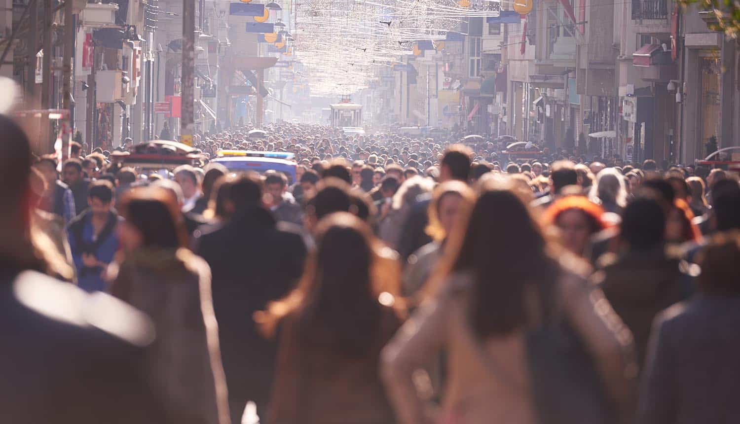 Image of crowded street with blurred faces representing how privacy and anonymity can be achieved in the age of big data