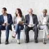 Image of people sitting in chairs waiting for interview signifying rise in GDPR jobs as compliance deadline looms