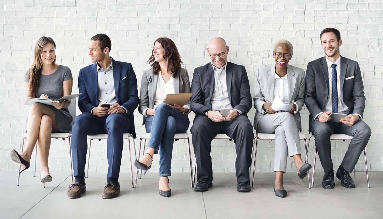 Image of people sitting in chairs waiting for interview signifying rise in GDPR jobs as compliance deadline looms