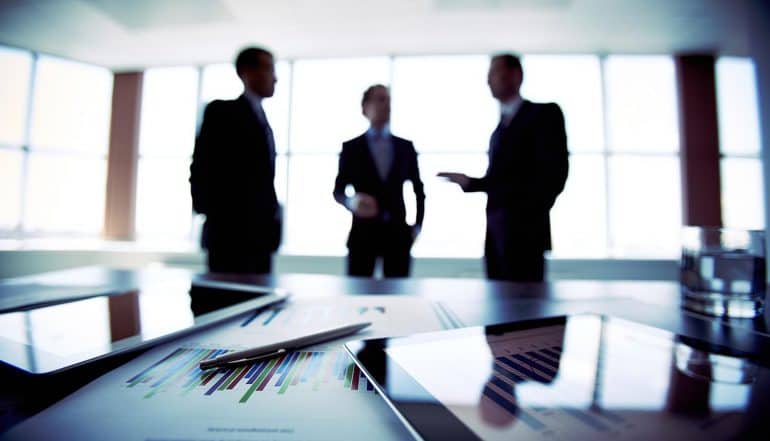 Image of business executives in a boardroom representing how governance of data should be on the agenda of all board director