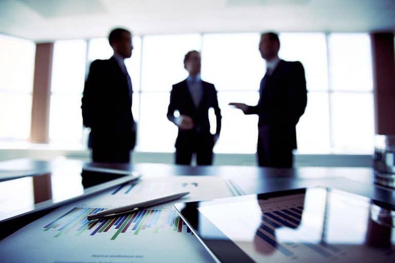 Image of business executives in a boardroom representing how governance of data should be on the agenda of all board director