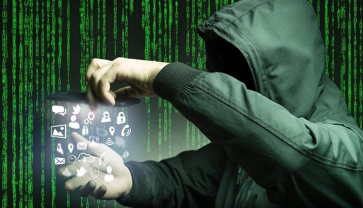 Image of hacker taking data from mobile phone representing how malware like fake WhatsApp and Lovelly Wallpaper begs the question of whether the Play Store can still be trusted