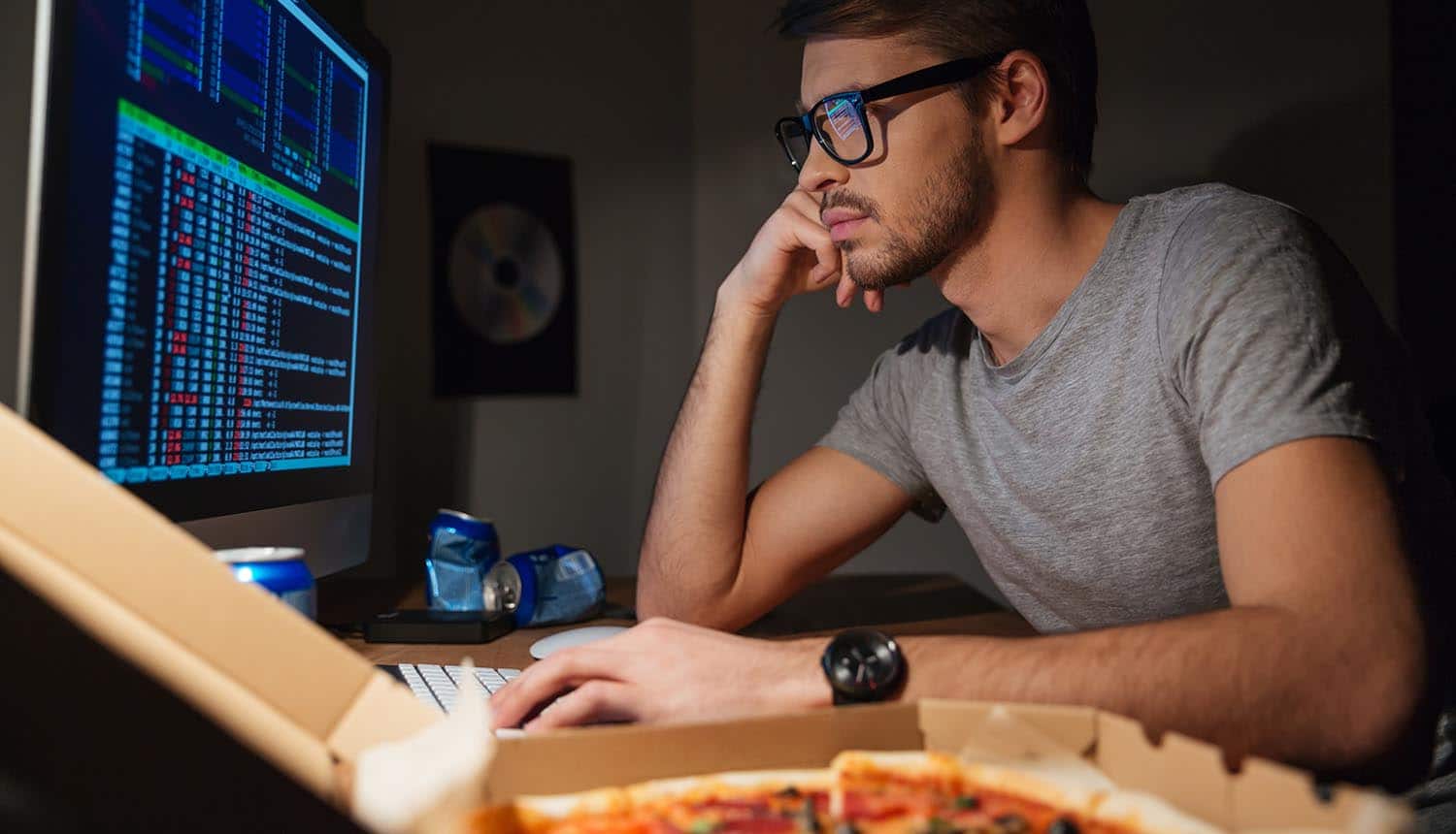 Image of developer in front of screen writing secure code code