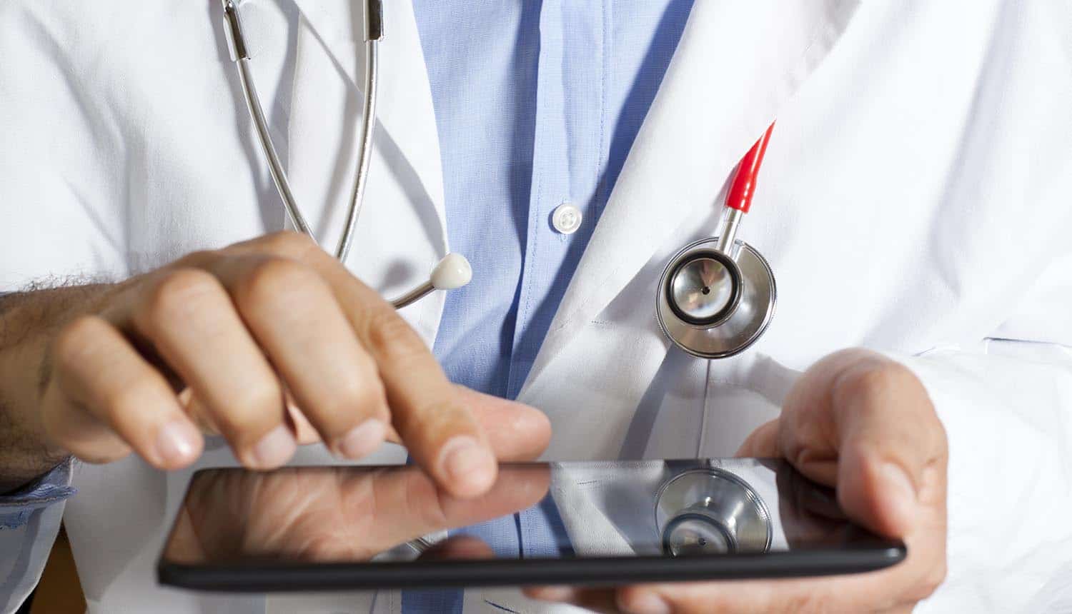 Image of doctor with stethoscope around neck and holding a tablet signifying the protection of information and privacy of the deceased