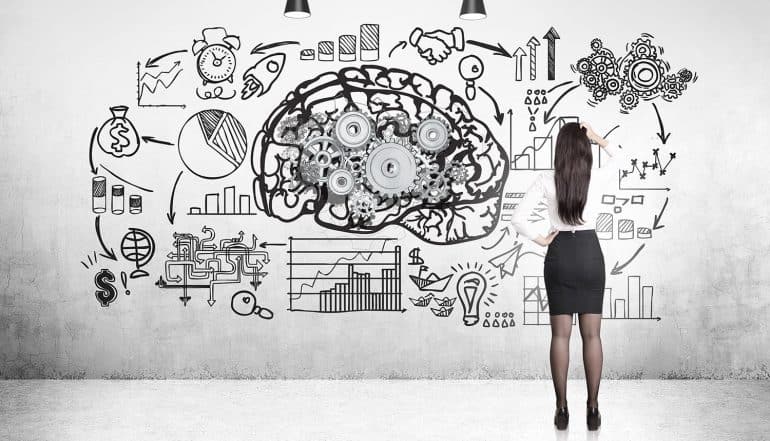 Image of woman standing in front of a walll with a brain and plans signifying the privacy challenge of artificial intelligence