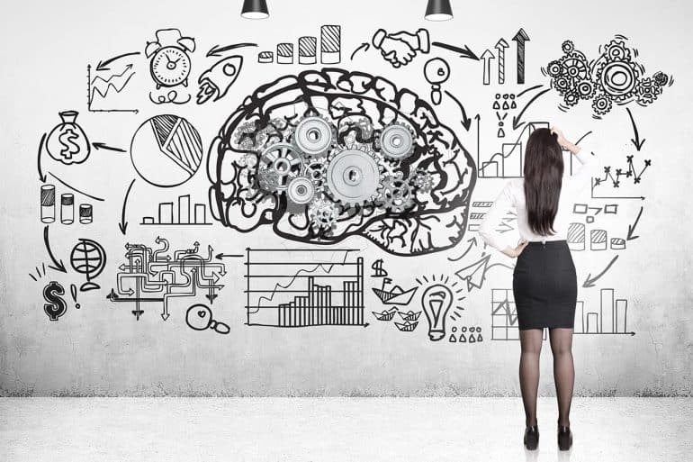 Image of woman standing in front of a walll with a brain and plans signifying the privacy challenge of artificial intelligence