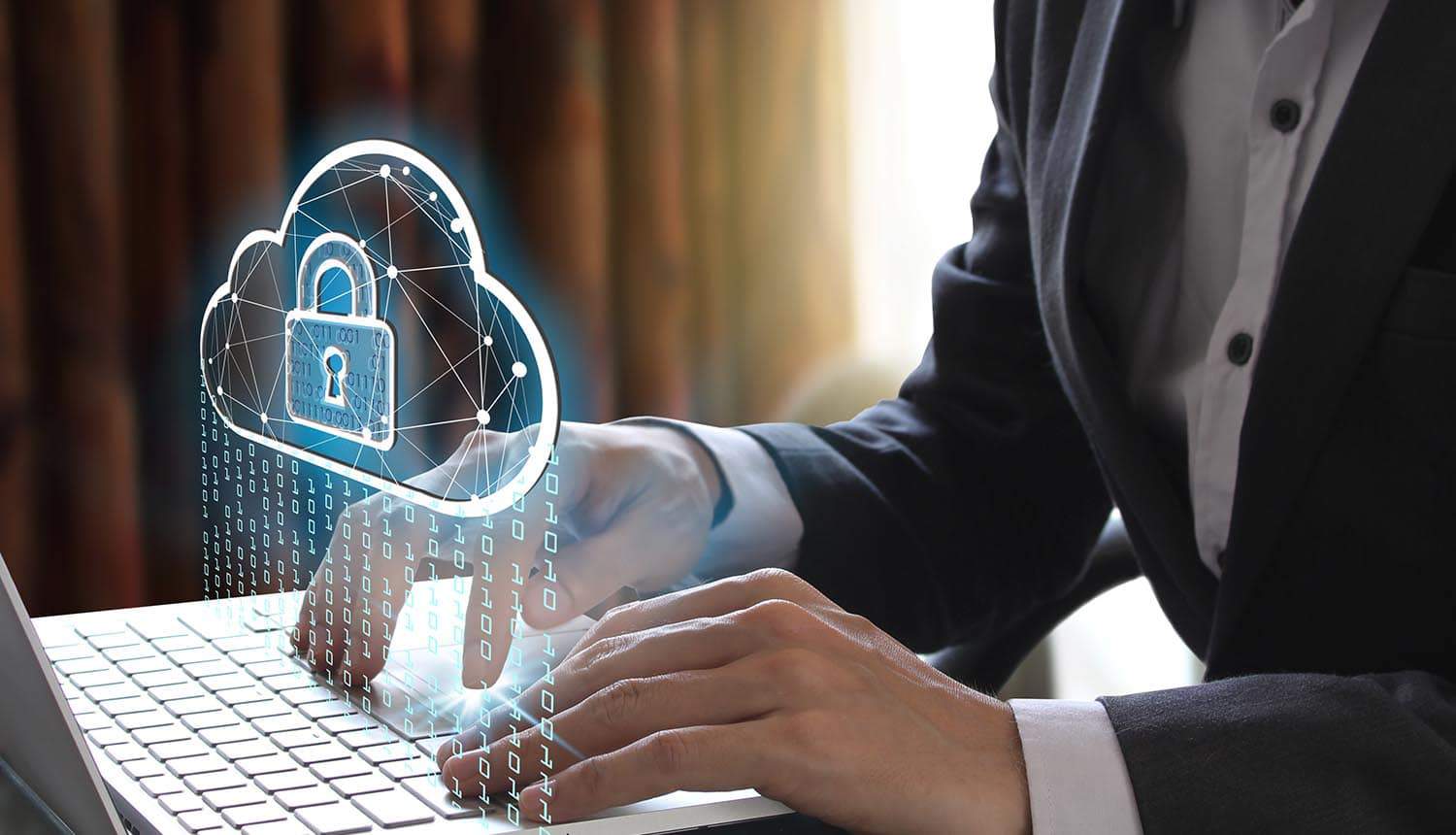 Image of man typing on laptop and sending data to cloud service providers which is protecting data