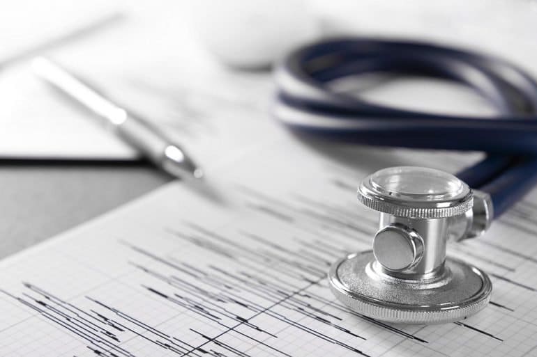 Image of stethoscope on heartbeat chart showing how privacy management software is needed
