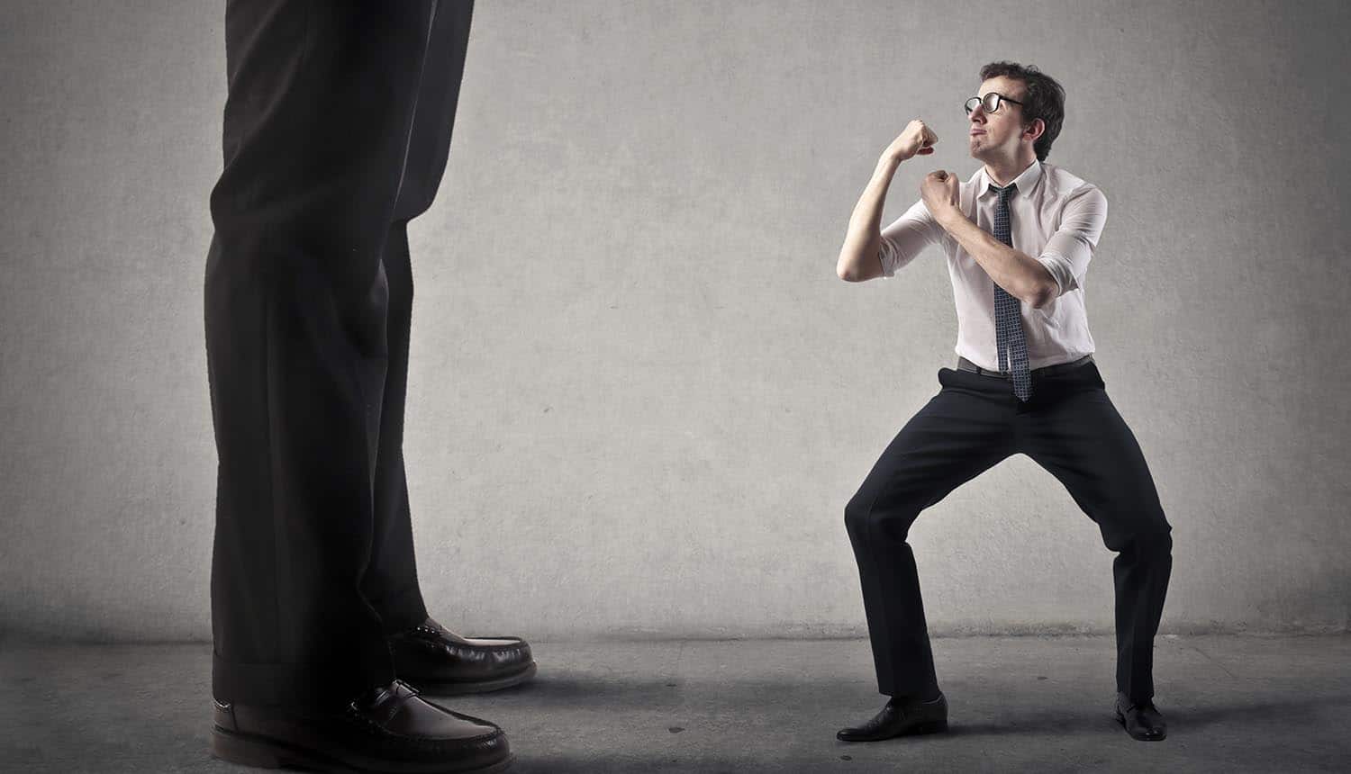 Image of small man fighting corporate giant