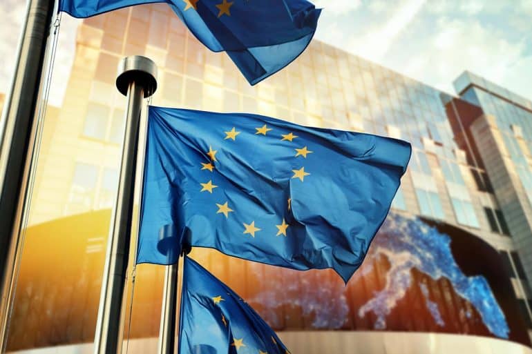 EU flags waving in front of European Parliament building