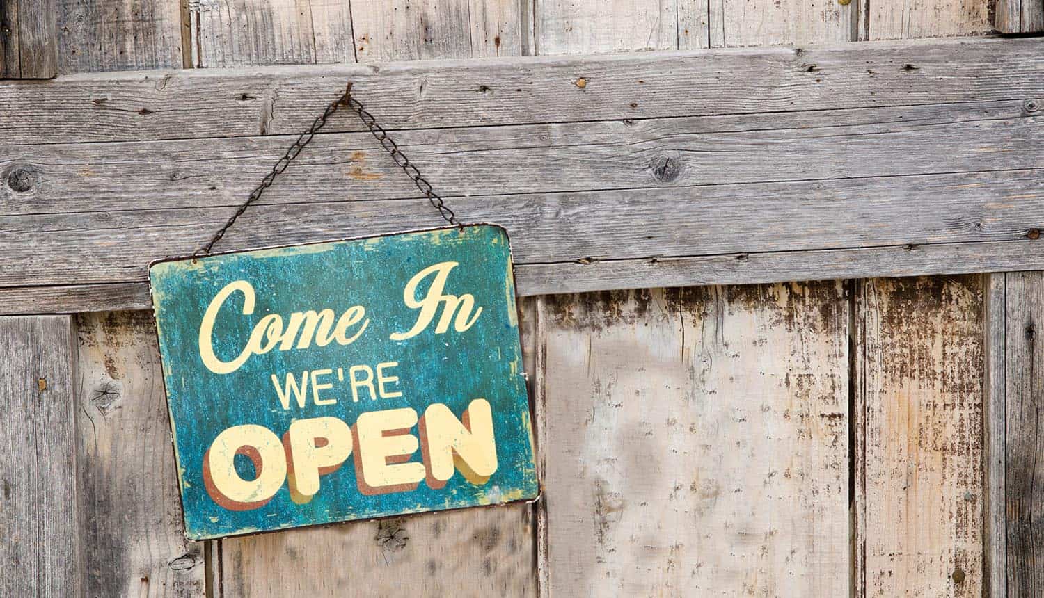 Vintage open sign on old wooden door showing the need for data transparency for customer loyalty