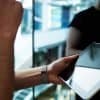 Business executive using wireless devices in modern office showing IoT in the workplace