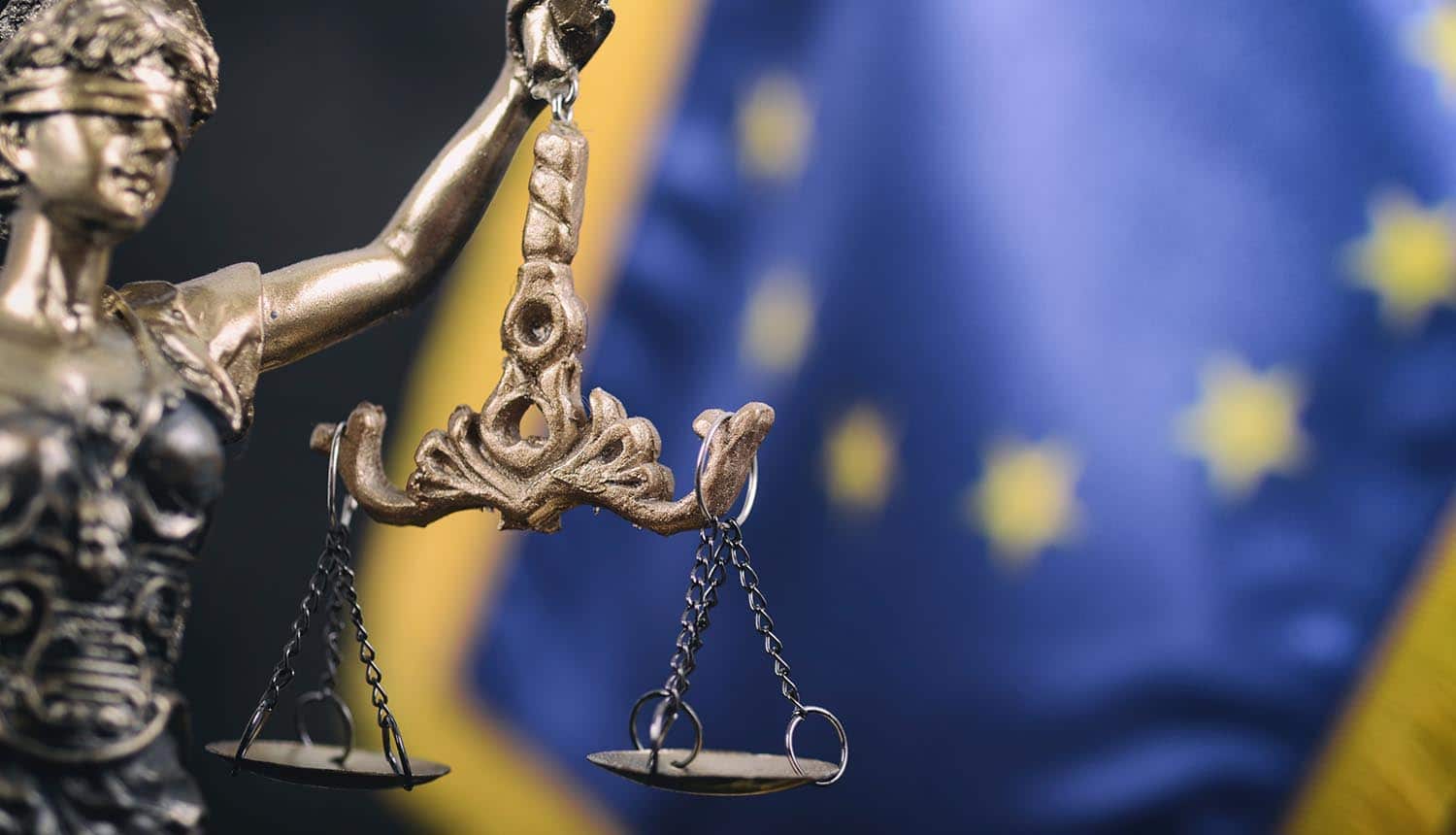 Lady Justice in front of the European Union flag in the background showing expectations of EU GDPR fines and sanctions