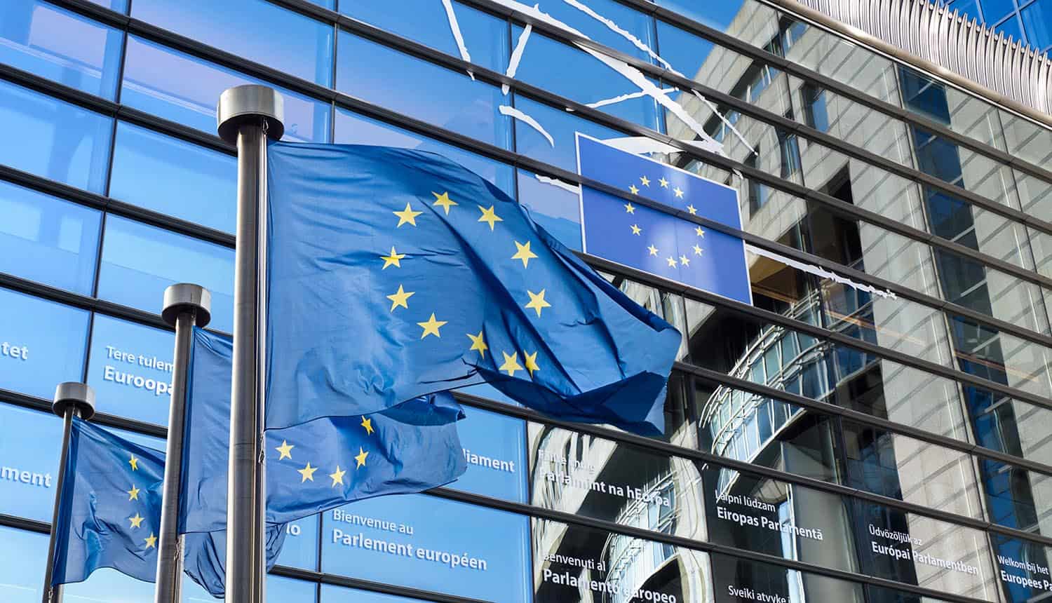 European Union flags in front of the European Parliament in Brussels, Belgium showing uncertainty with GDPR