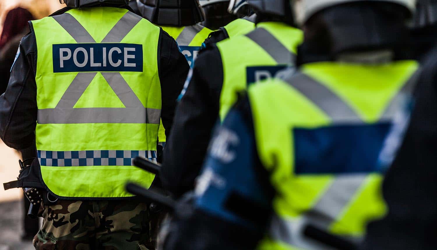 Police in riot gear heading towards crime area shows use of crime data to reduce criminal activity