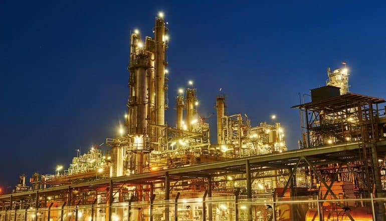 Oil refinery plant of petroleum showing critical infrastructure facing increasing cybersecurity regulations