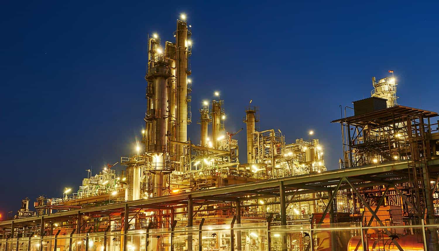 Oil refinery plant of petroleum showing critical infrastructure facing increasing cybersecurity regulations