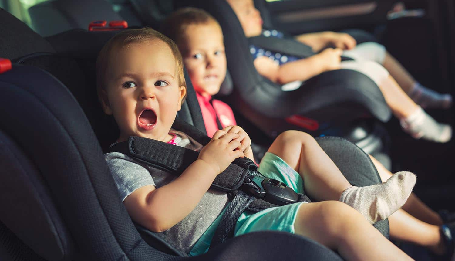 Children in car seats with a shocked look showing concern over data privacy