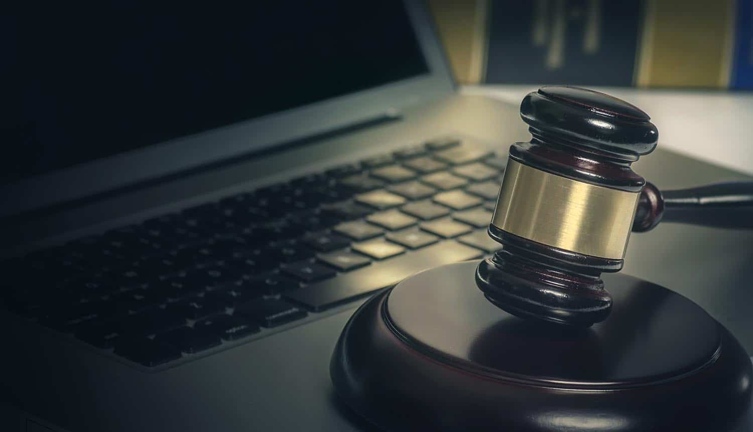 Hammer and gavel in front of laptop showing tightening of data breach notification laws