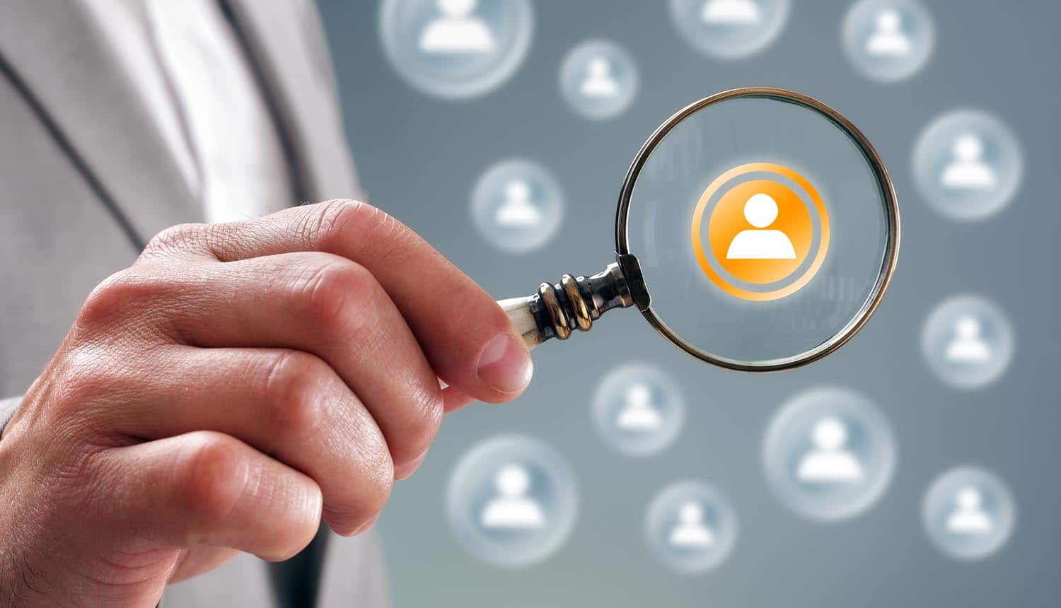Businessman with magnifying glass on people icons showing targeted Facebook advertising and LinkedIn's privacy violation