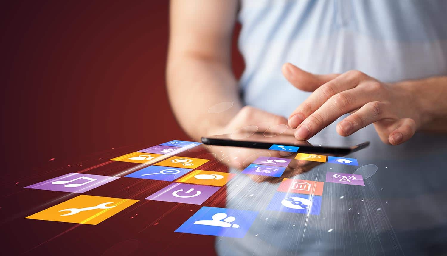 Hand holding mobile device and installing freemium mobile apps