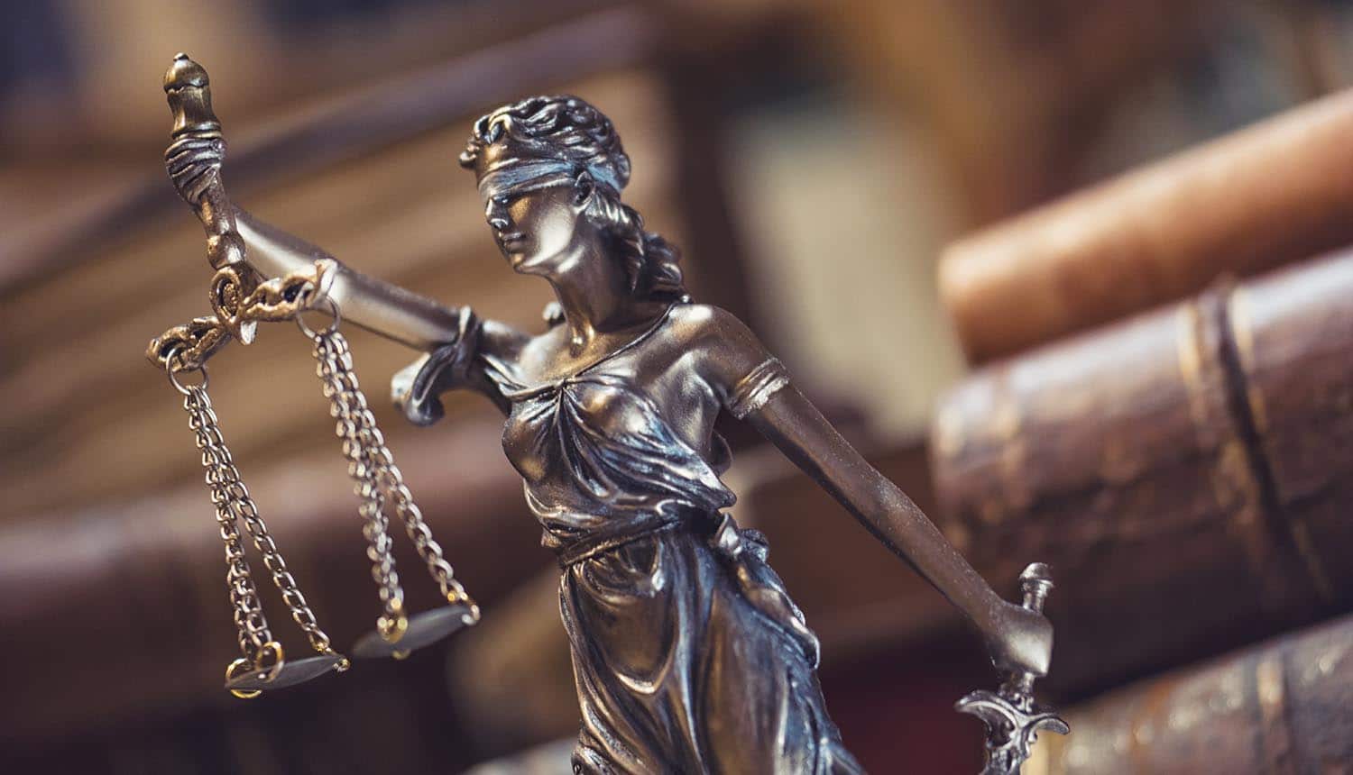 The statue of Justice against a background of old books showing the considerations for a national data privacy law