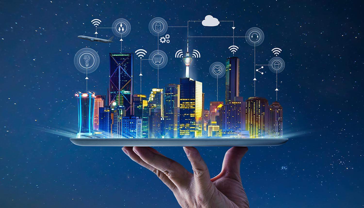 Hand holding an empty digital tablet with Smart city with smart services and icons of internet of things showing smart cities embracing digital rights
