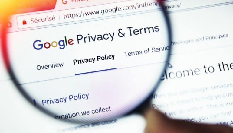 Privacy terms on Google website magnified with magnifying glass showing the cause of GDPR fines