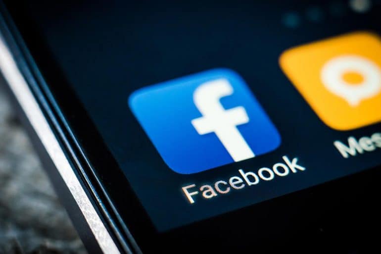 Facebook android app icon on a smartphone screen showing how personal data is shared without user consent
