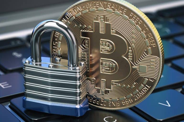 Cryptocurrency bitcoin coin and padlock lock on computer keyboard showing crypto-regulations for virtual currencies