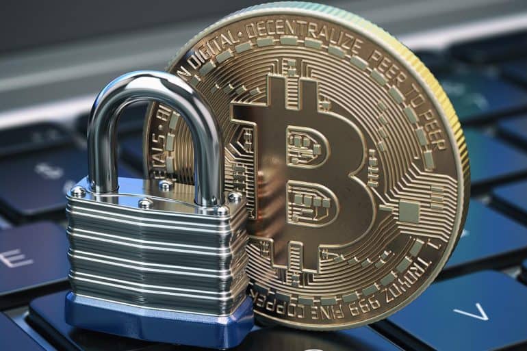 Cryptocurrency bitcoin coin and padlock lock on computer keyboard