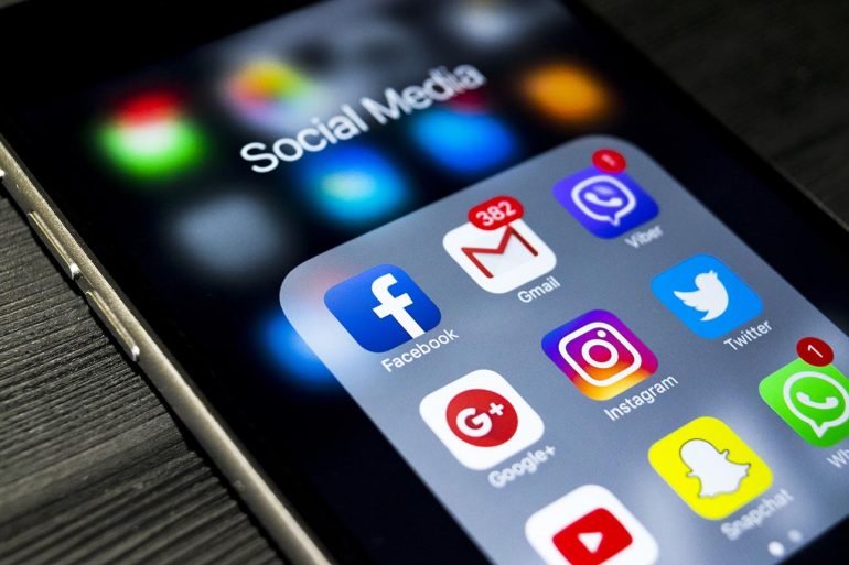 Mobile phone with icons of social media showing difficulty of social media privacy