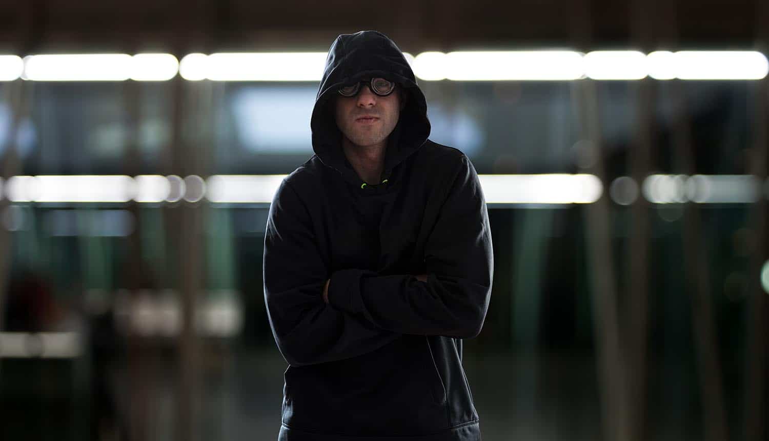 Hacker looking smug and standing with arms crossed showing the need for faster cyber response