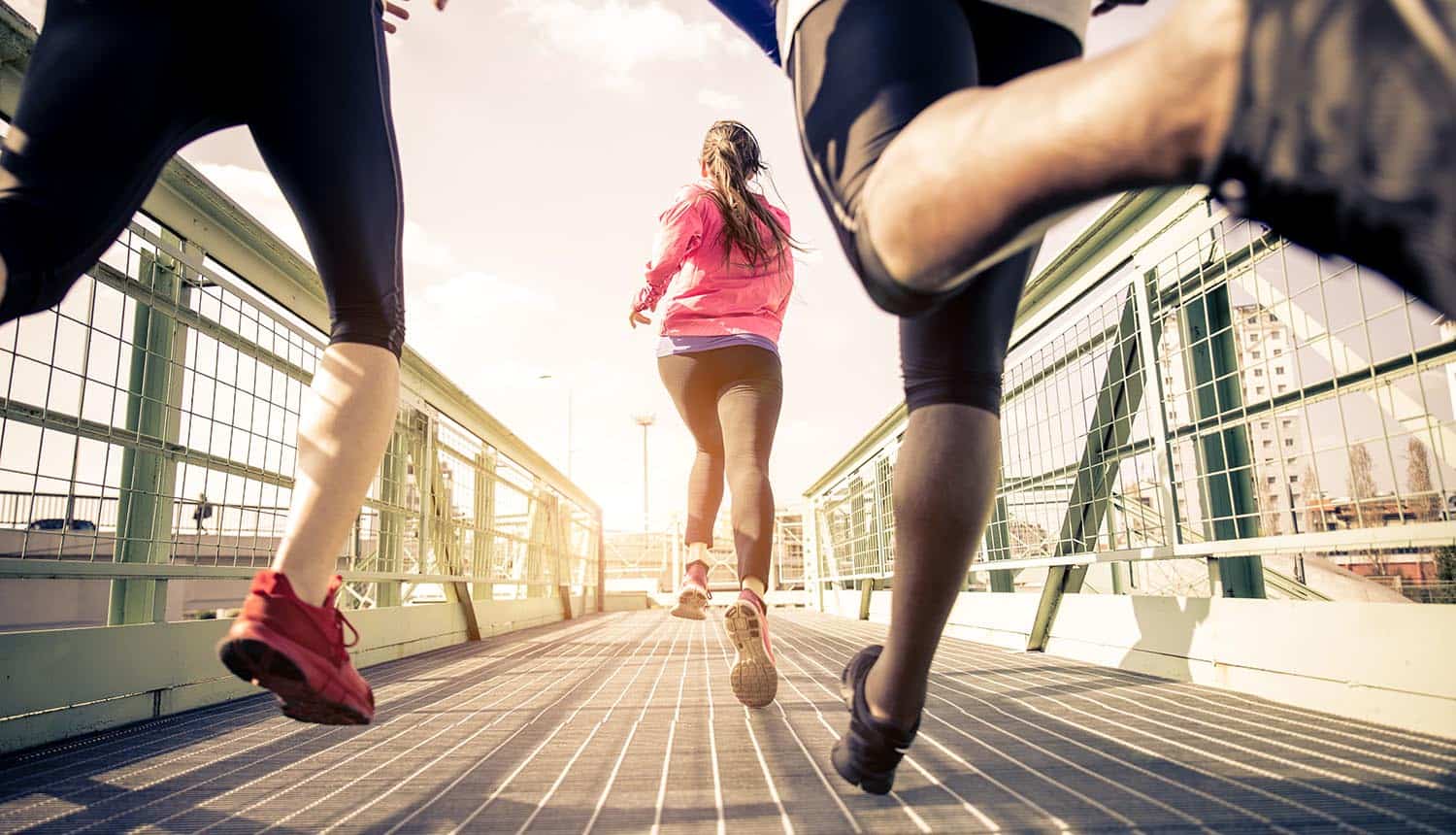 Three runners sprinting outdoors showing the cybersecurity arms race