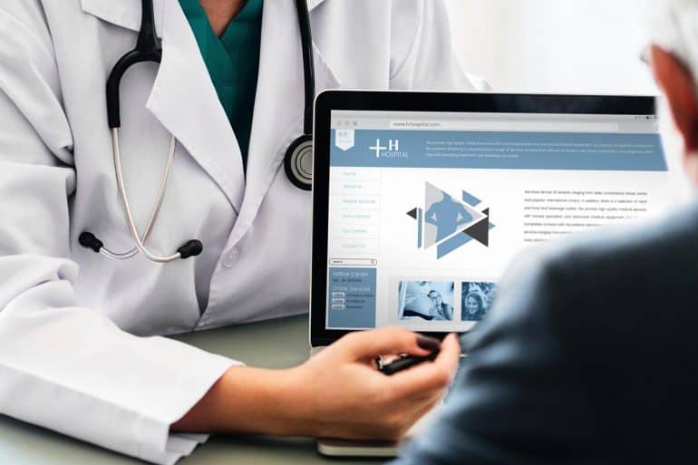Doctor explaining medical information to patient showing the need for HIPAA compliant patient communication