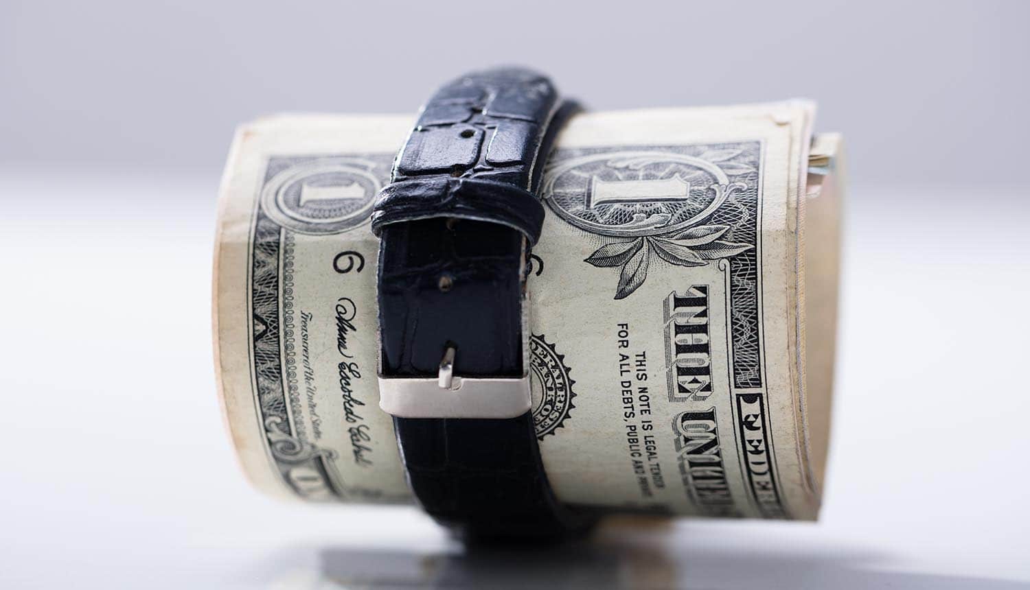 Rolled up dollar banknotes tied with belt showing the cost of privacy regulations on small businesses