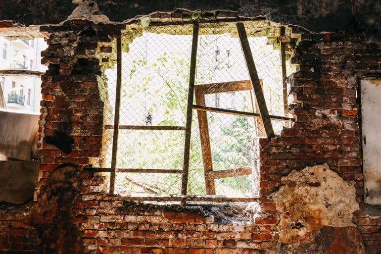Inside ruined abandoned house building after disaster showing the impact of data breach on disaster survivors