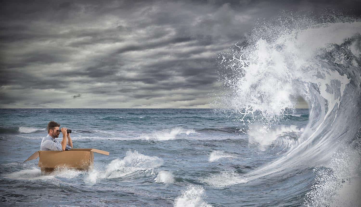 Businessman in a cardboard sails in a storm at sea showing how organizations cope with GDPR and CCPA regulations
