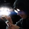 Hacker touching a smart phone screen showing how hackers attack mobile apps and the methods to protect against it