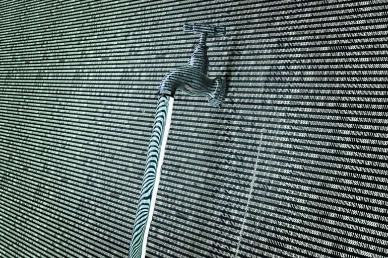 Concept of leaky software data with a tap sticking out showing largest email data breach in history