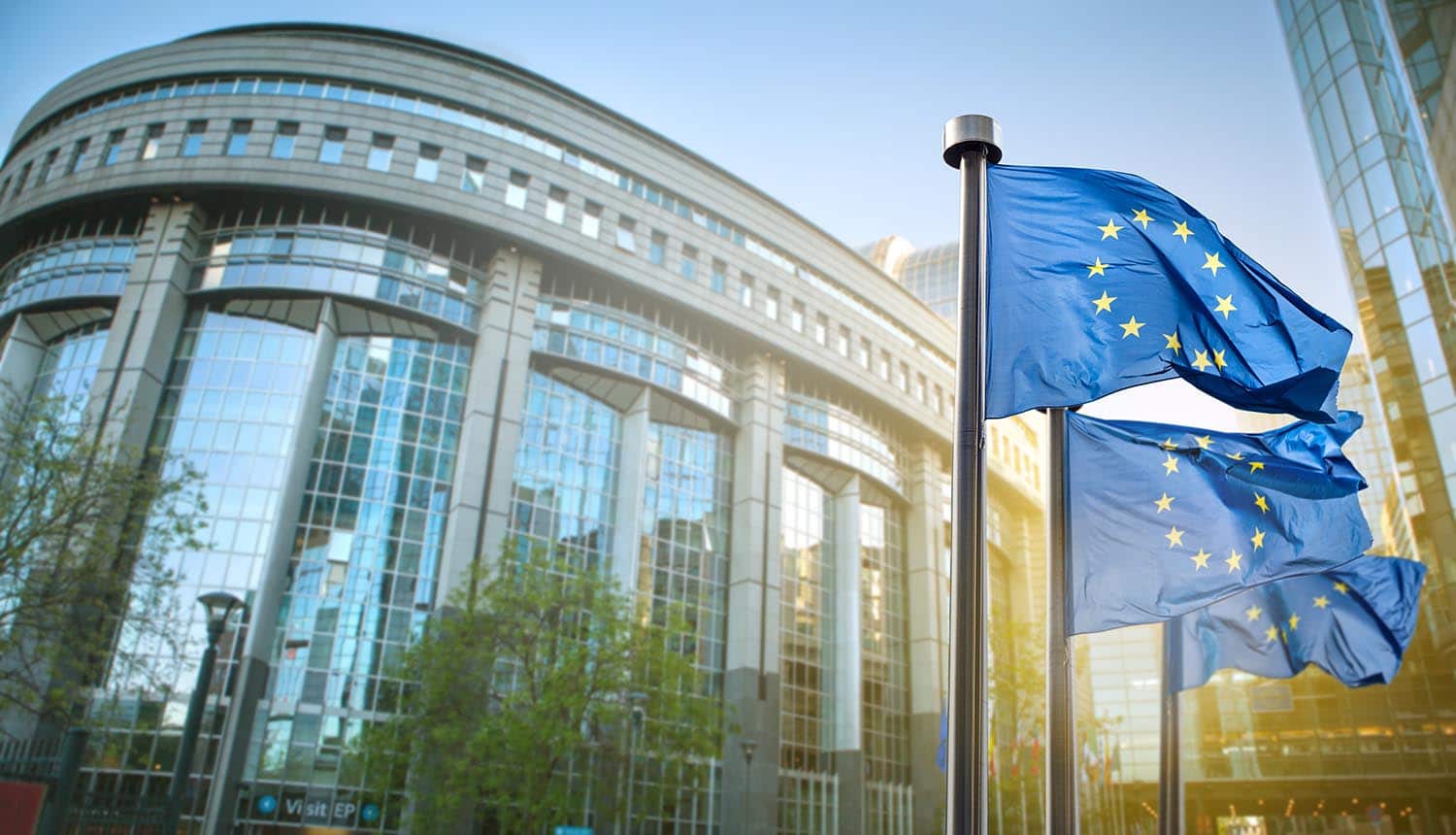 European union flag against parliament showing cybersecurity challenges released in new briefing paper by European Court of Auditors