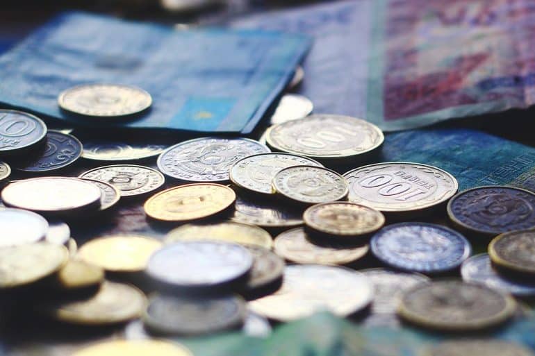 Currencies banknotes and coins showing evolution of cyber threats to international payment flows